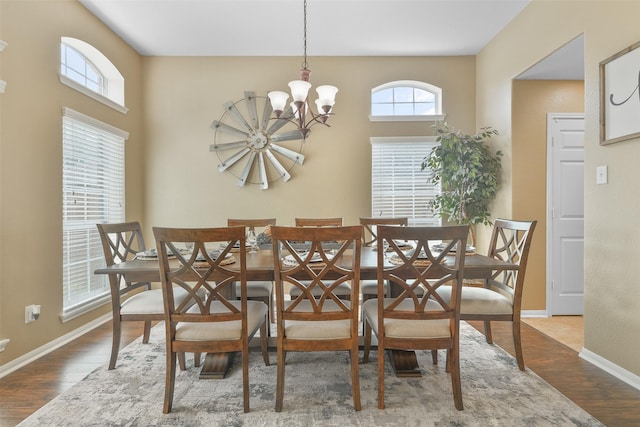 dining area featuring an inviting chandelier and hardwood / wood-style flooring