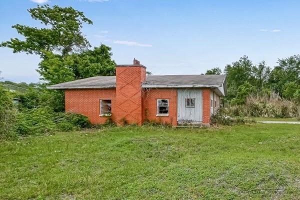 back of house with a lawn