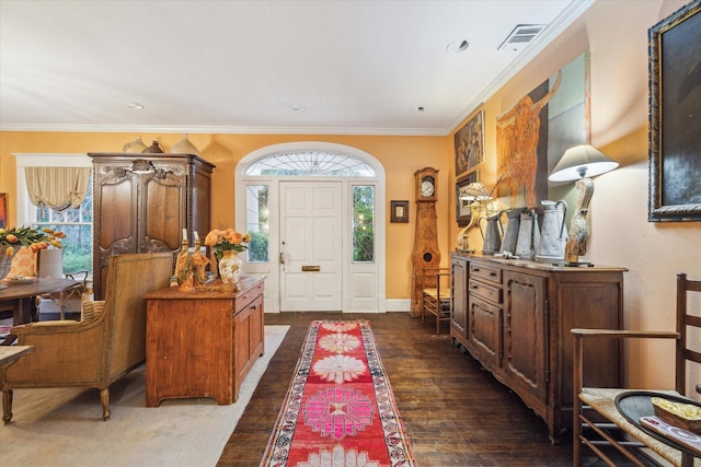 entryway with ornamental molding and dark wood-type flooring