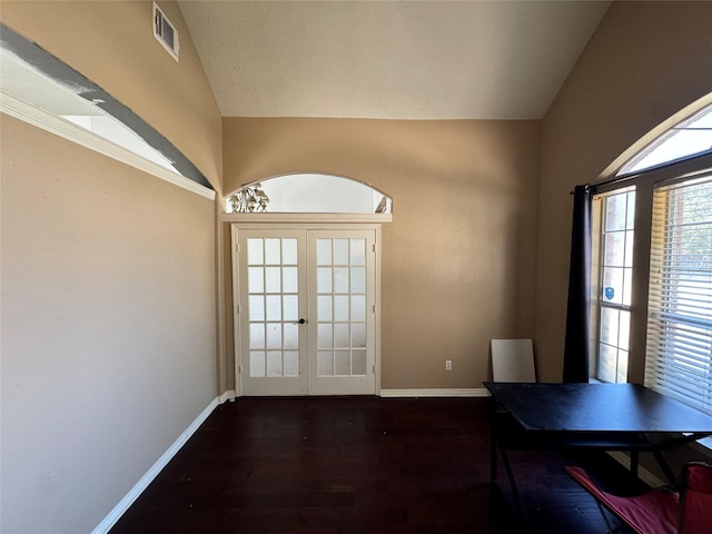 doorway to outside with french doors, vaulted ceiling, and dark wood-type flooring