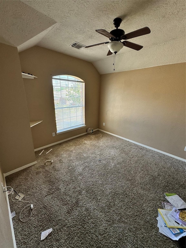 unfurnished room featuring a textured ceiling, ceiling fan, lofted ceiling, and carpet flooring