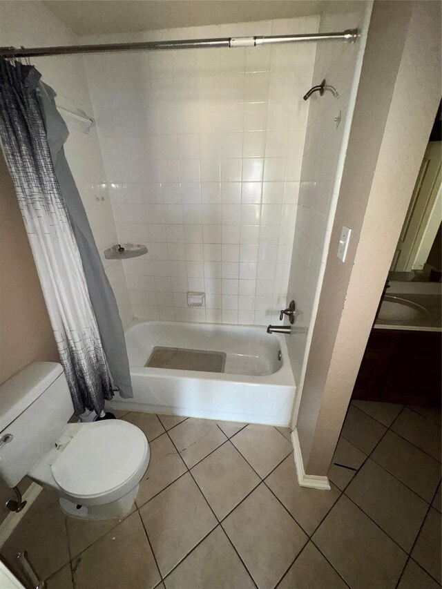 bathroom featuring toilet, tile patterned floors, and shower / tub combo with curtain