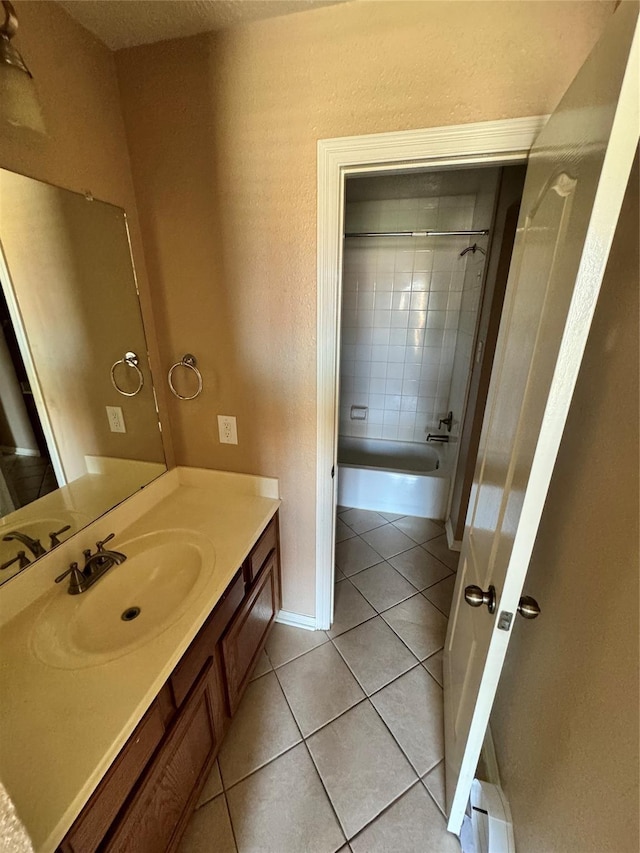 bathroom with vanity, tile patterned floors, and tiled shower / bath