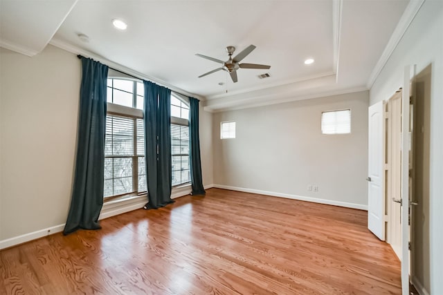 spare room with ceiling fan, a wealth of natural light, ornamental molding, and light hardwood / wood-style floors