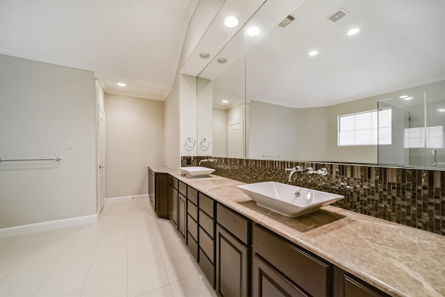 bathroom featuring tile patterned floors, vanity, an enclosed shower, and tasteful backsplash