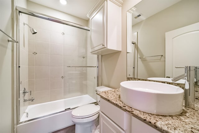 full bathroom with shower / bath combination with glass door, vanity, and toilet