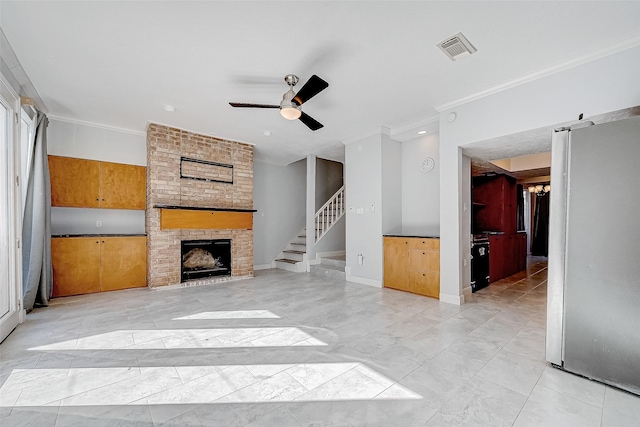 unfurnished living room with ceiling fan, a fireplace, and ornamental molding