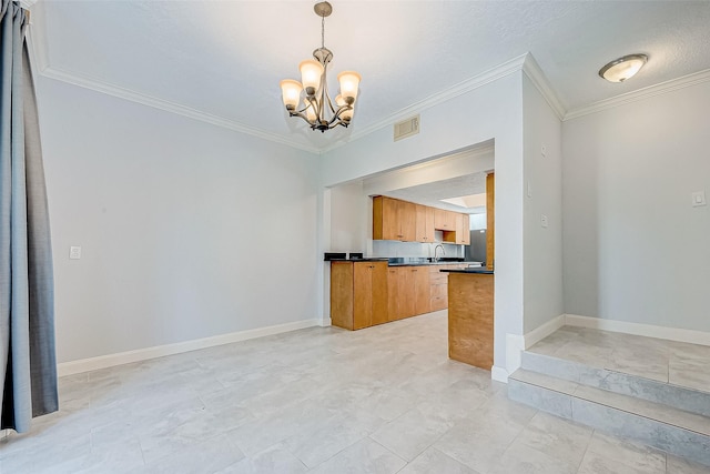 kitchen with sink, pendant lighting, ornamental molding, and an inviting chandelier