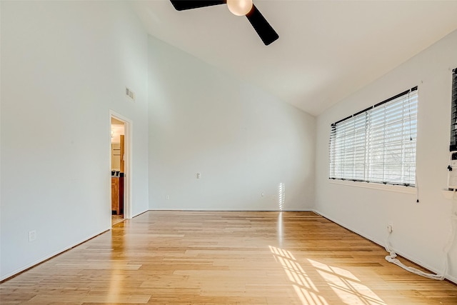 spare room with ceiling fan, lofted ceiling, and light hardwood / wood-style flooring