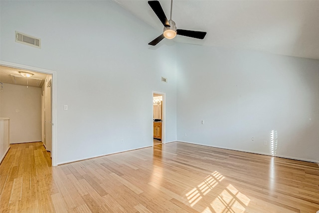 empty room with ceiling fan, light hardwood / wood-style floors, and high vaulted ceiling