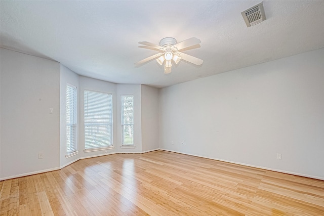 unfurnished room with light wood-type flooring and ceiling fan