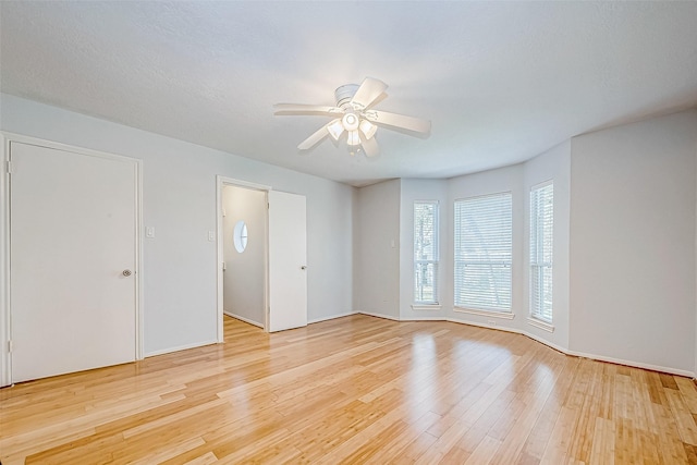 unfurnished room featuring light hardwood / wood-style floors and ceiling fan