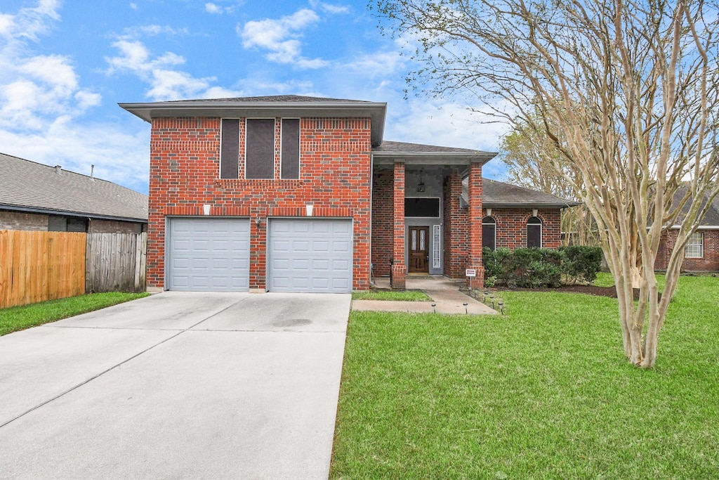 tri-level home with a front yard and a garage