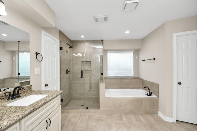 bathroom with shower with separate bathtub, vanity, and tile patterned floors