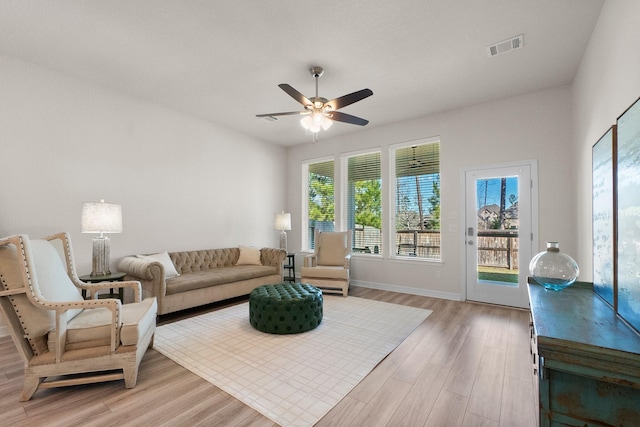 living room featuring ceiling fan and hardwood / wood-style flooring