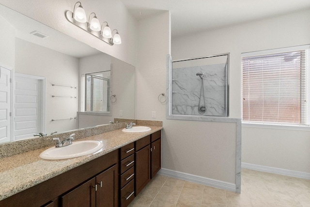 bathroom with vanity, tile patterned floors, and a shower