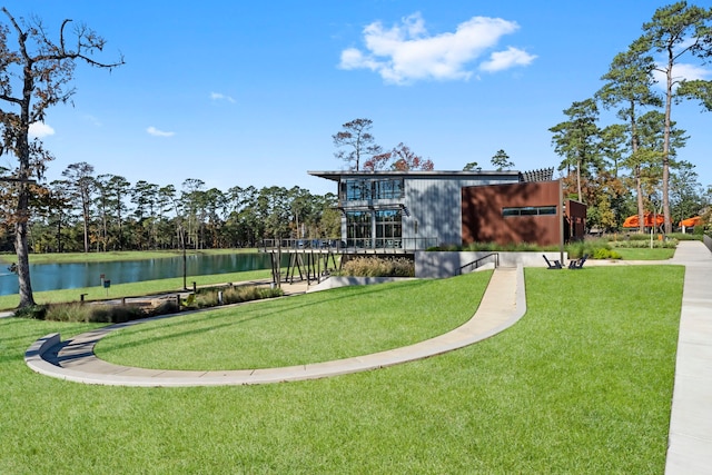 surrounding community with a lawn and a water view