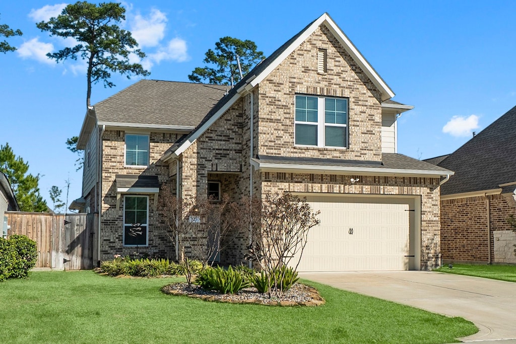 view of front of home featuring a front yard and a garage