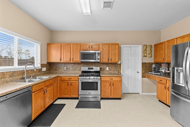 kitchen featuring tasteful backsplash, sink, and stainless steel appliances