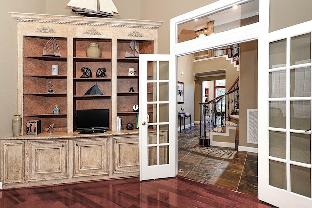 home office featuring dark hardwood / wood-style flooring and french doors