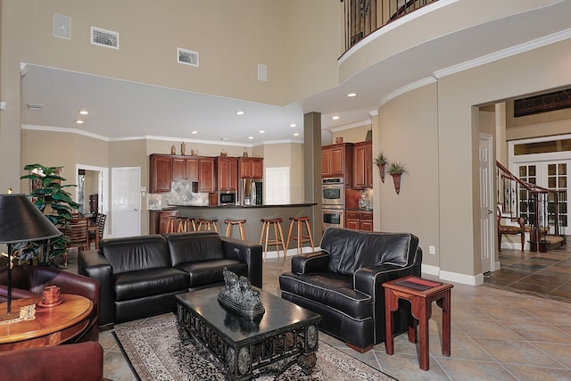 living room with crown molding and a high ceiling