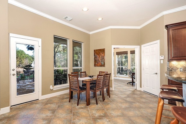 dining area featuring crown molding