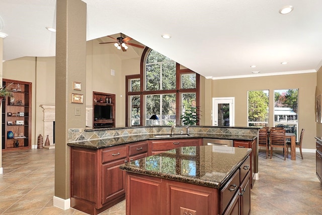 kitchen featuring a kitchen island, dishwasher, sink, dark stone countertops, and kitchen peninsula