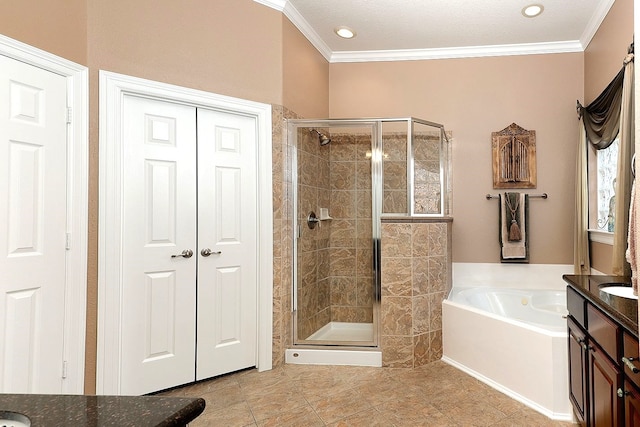 bathroom featuring crown molding, vanity, and independent shower and bath