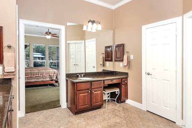 bathroom featuring crown molding, ceiling fan, and vanity