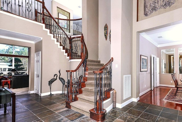 foyer featuring a high ceiling and crown molding