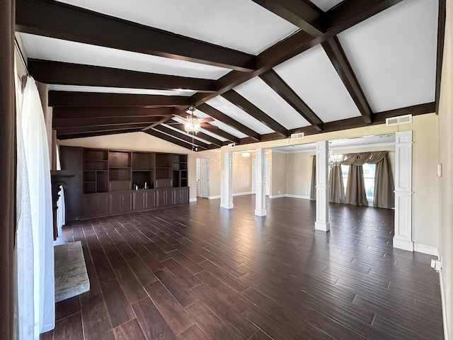 unfurnished living room with vaulted ceiling with beams, dark hardwood / wood-style floors, a chandelier, and ornate columns