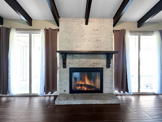 interior details featuring a brick fireplace and beam ceiling