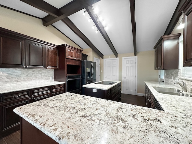 kitchen featuring sink, black appliances, tasteful backsplash, and a center island