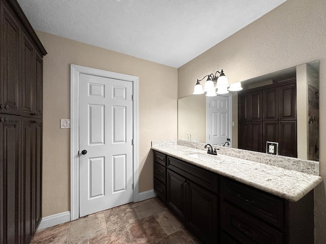 bathroom featuring vanity and a textured ceiling