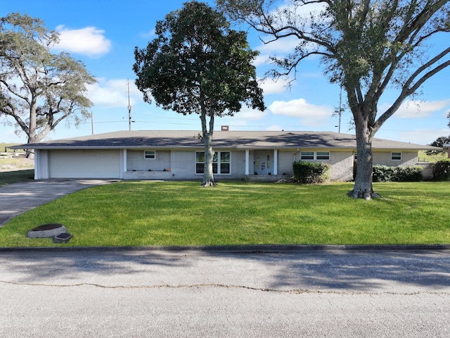 ranch-style home with a garage and a front lawn