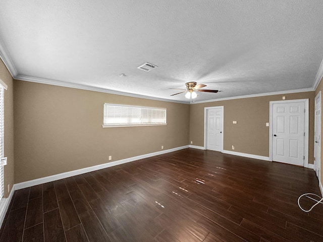 unfurnished room featuring dark wood-type flooring, ornamental molding, and a textured ceiling