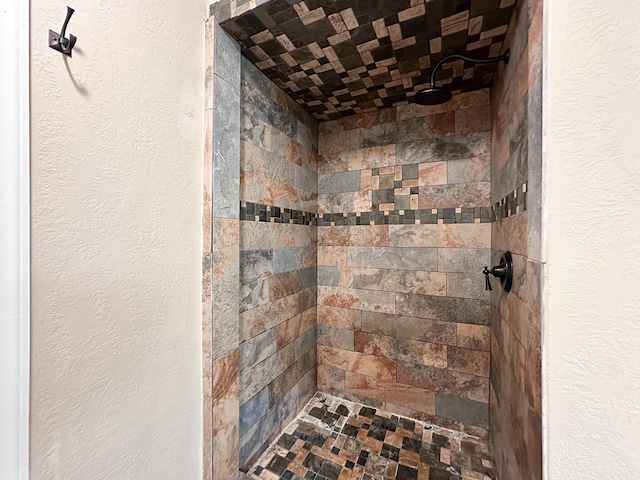 bathroom with tiled shower