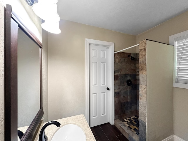 bathroom featuring vanity and a tile shower