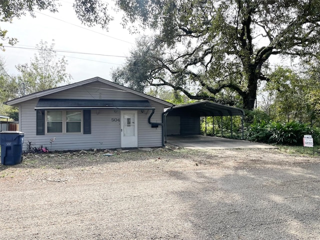 view of front of property featuring a carport