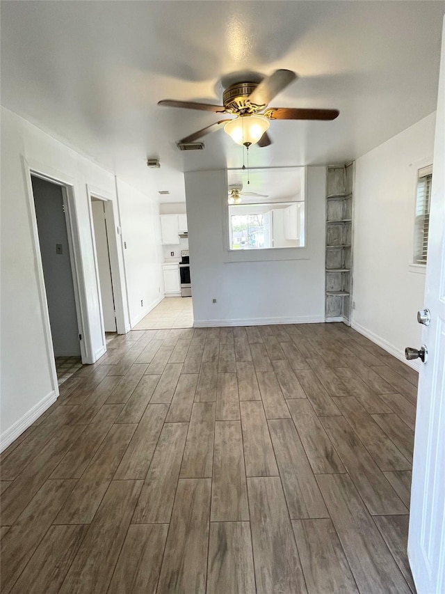 unfurnished living room featuring ceiling fan