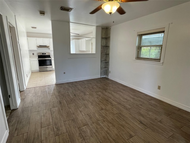 unfurnished living room featuring ceiling fan