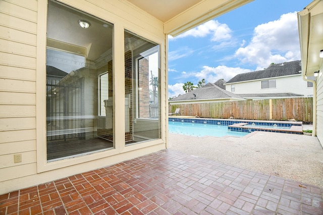 view of pool with a patio and an in ground hot tub