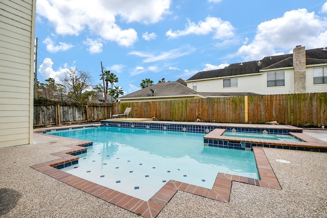 view of pool featuring an in ground hot tub