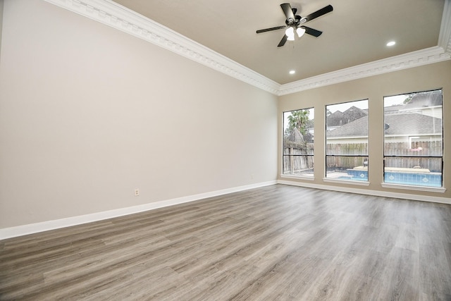 spare room with ceiling fan, wood-type flooring, and crown molding