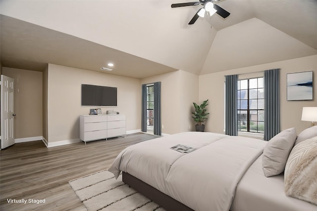 bedroom with ceiling fan, hardwood / wood-style floors, and lofted ceiling