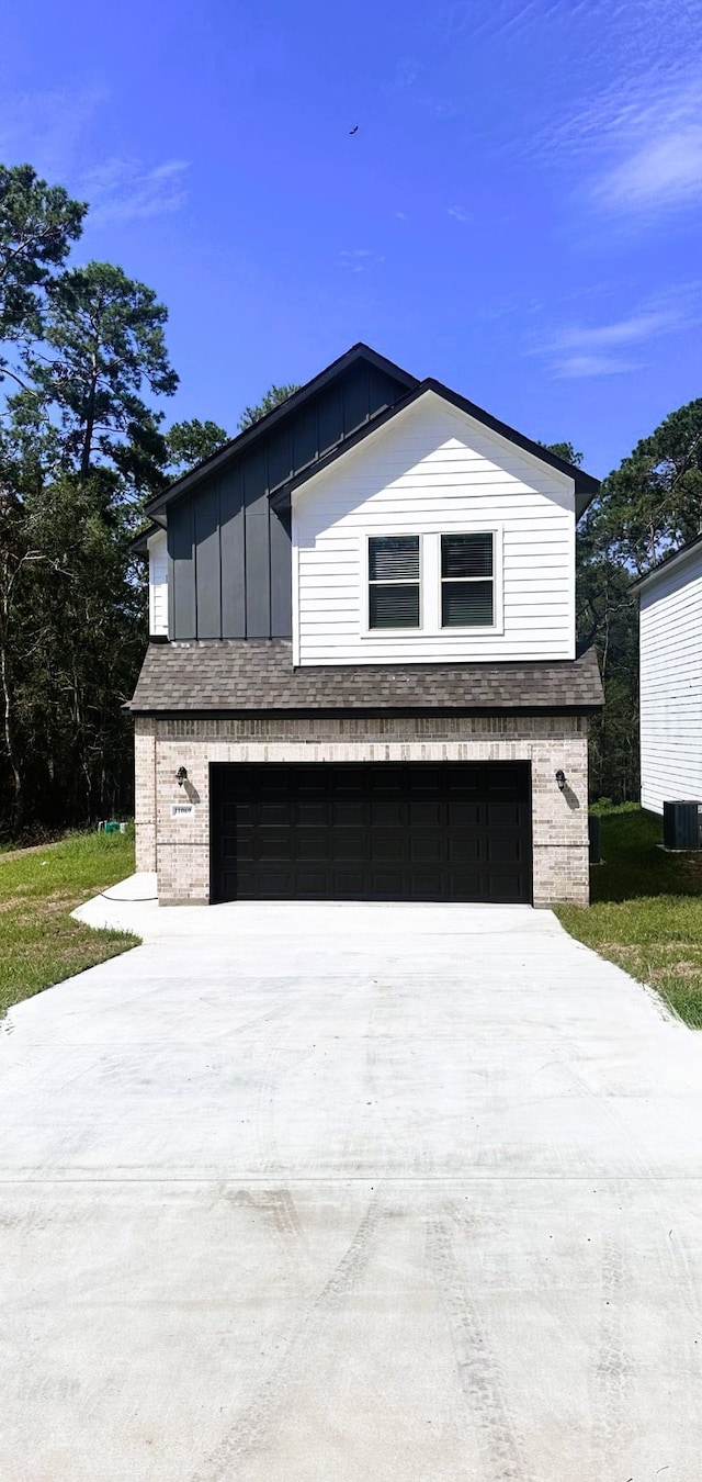 view of side of home featuring central AC and a garage