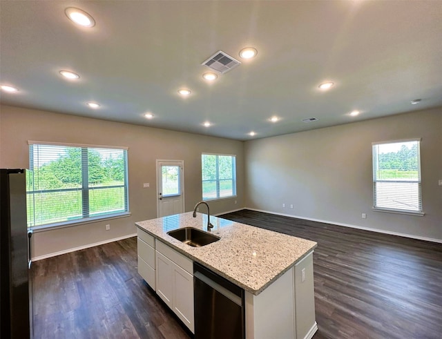 kitchen featuring light stone counters, an island with sink, white cabinetry, black dishwasher, and sink