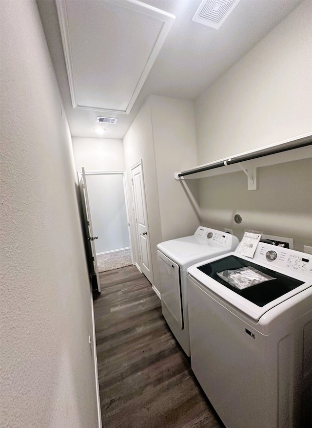 laundry room featuring washing machine and dryer and dark hardwood / wood-style floors