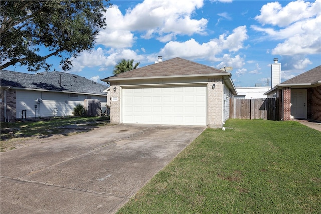 view of side of home featuring a garage and a lawn