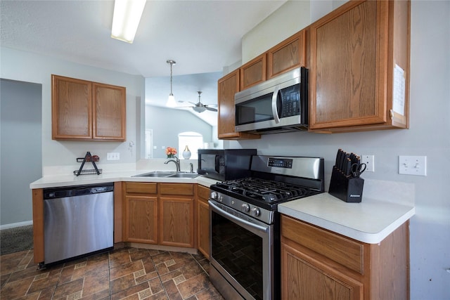 kitchen with ceiling fan, appliances with stainless steel finishes, lofted ceiling, pendant lighting, and sink